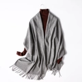 Grey wool blend knitted shawl with fringe tassels over a brown turtleneck sweater - Medium Grey