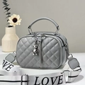 Close-up of gray quilted crossbody bag with triple zippers and LOVE woven strap - Gray
