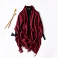 Solid wine red wool scarf with fringe trim worn over a black turtleneck sweater - Burgundy