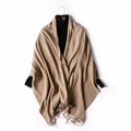 Camel knitted wool shawl with fringe detail over a black turtleneck sweater - Khaki