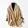 Beige wool blend pashmina scarf with tassel fringe on a black turtleneck top - Light Camel