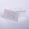 Macro shot of silver polishing cloths with printed logo for jewelry maintenance - White Polishing Cloth