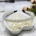 Detail view of woven beaded headband and white pearl necklace in a heart-shaped bowl - Silver White (C7531)