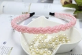 Detail of pink beaded braided headband with pearl texture on a white ceramic heart dish - Pink (C7130)