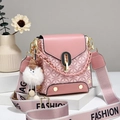 Pink mini crossbody phone bag with geometric patterns and a white pompom charm - Pink