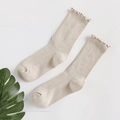 Beige ribbed cotton socks with ruffled wood ear trim detail on a white background - One Size / Nude
