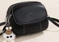 Black multi-zipper shoulder bag with white contrast stitching and plush charm - Solid Black