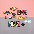 Colorful embroidered patches with love, peace and planet motifs on a two-tone background - Full Set of 11