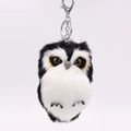 Detail of owl plush keychain featuring soft faux fur texture and metal lobster clasp - Black