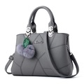 Elegant grey faux leather tote bag with embroidery stitching and fuzzy ball pendant charm - Gray