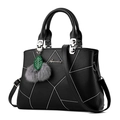 Elegant black lychee leather handbag with white geometric stitching and furry pendant decor - Black