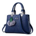 Navy blue faux leather handbag with geometric stitching and pompom charm detail - Sapphire Blue