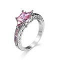 Elegant silver ring with pink princess cut gemstone and sparkling side stones - White Gold & Pink