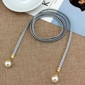 Elegant grey woven belt with golden tips and faux pearl pendants on textured linen - Silver