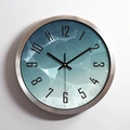 Modern round wall clock with brushed metal frame and blue geometric gradient dial design - Silver