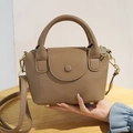 Chic brown lychee grain leather bucket bag with dual handles and gold-tone hardware - Brown
