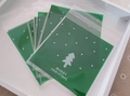 Christmas tree patterned self-sealing candy bags with Merry Christmas text on a tray - 10*10+3 Christmas Tree-Green
