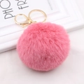 Detail of pink fluffy faux rabbit fur keychain with a gold metal lobster clasp - Medium Pink