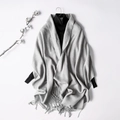 Elegant grey wool blend scarf with fringe detail over a black turtleneck sweater - Light Gray