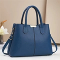 Blue lychee leather handbag with dual handles and gold metal accents for women - Blue