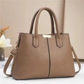 Detail of brown litchi pattern leather handbag with golden clasp and dual handles - Khaki