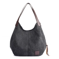 Minimalist black canvas tote bag with brown leather handles and side fringe accents - Black