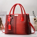 Red crocodile embossed women's handbag with gold hardware and shoulder strap - Red