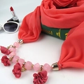 Detail of red chiffon scarf necklace with pink floral pendant and beaded chain accents - Watermelon red