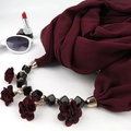 Detail of burgundy floral pendant scarf with metal buckle and beads on white background - Wine Red