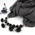 Detail of dark grey scarf with floral pendant and black beads on white background - Dark Gray