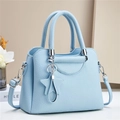 Close-up of light blue lychee pattern faux leather handbag with silver hardware details - Blue