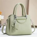 Detail of light green litchi grain leather bag with star charm and silver hardware - Green