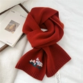 Detail view of deep red knitted wool scarf featuring delicate floral embroidery texture - 19x166cm / Red