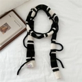 Detailed knit texture of green and white striped scarf with decorative fringed ends - Black Stripe