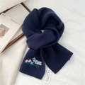 Detailed close-up of floral embroidery on a dark blue knitted wool scarf for winter - 19x166cm / Navy Blue