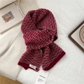 Close-up of red and white striped knit scarf with soft texture and brand label detail - Dotted Red