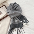 Detailed texture of grey herringbone lambswool scarf featuring soft fringe edges - 31x183cm / Gray