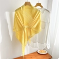 Detail of yellow hollow knit shawl in triangular knot style over white shirt - Yellow