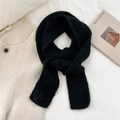 Close-up of black knit scarf with thick fluffy texture and soft pom-pom detail - Scarf / Black