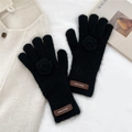 Detailed macro shot of black knit gloves with fuzzy texture and 3D floral decoration - Gloves / Black