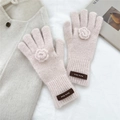 Detail of pink knitted mohair gloves featuring 3D floral accents and a leather tag - Gloves / Pink