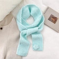 Detail of mint green knit scarf showing soft texture and 3D crochet flower ornament - Scarf / Blue