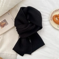 Detail of black wool blend knit scarf with ribbed texture and small brand woven label - Black