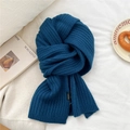 Detail of teal wool knit scarf with thick ribbed texture and brand woven label - Navy Blue