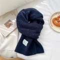 Detailed texture of navy knit scarf with multicolored speckles and white fabric label - Mélange Navy Blue