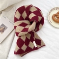 Detail of red and white argyle knit scarf with thick wool texture and fabric label - Red Rhombus