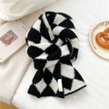 Detailed texture of thick black and white diamond lattice knitted winter scarf with label - Black Rhombus