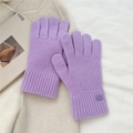 Close-up of light purple knitted winter glove with metal logo detail on ribbed wrist cuff - One Size / Purple