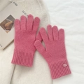 Detailed close-up of pink knitted gloves with ribbed windproof cuffs and soft texture - One Size / Pink