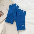 Close-up of bright blue knitted winter gloves with ribbed cuffs and metallic logo detail - One Size / Sapphire Blue